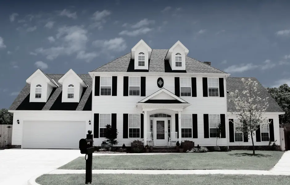 Large two-story home with white siding and black shutters